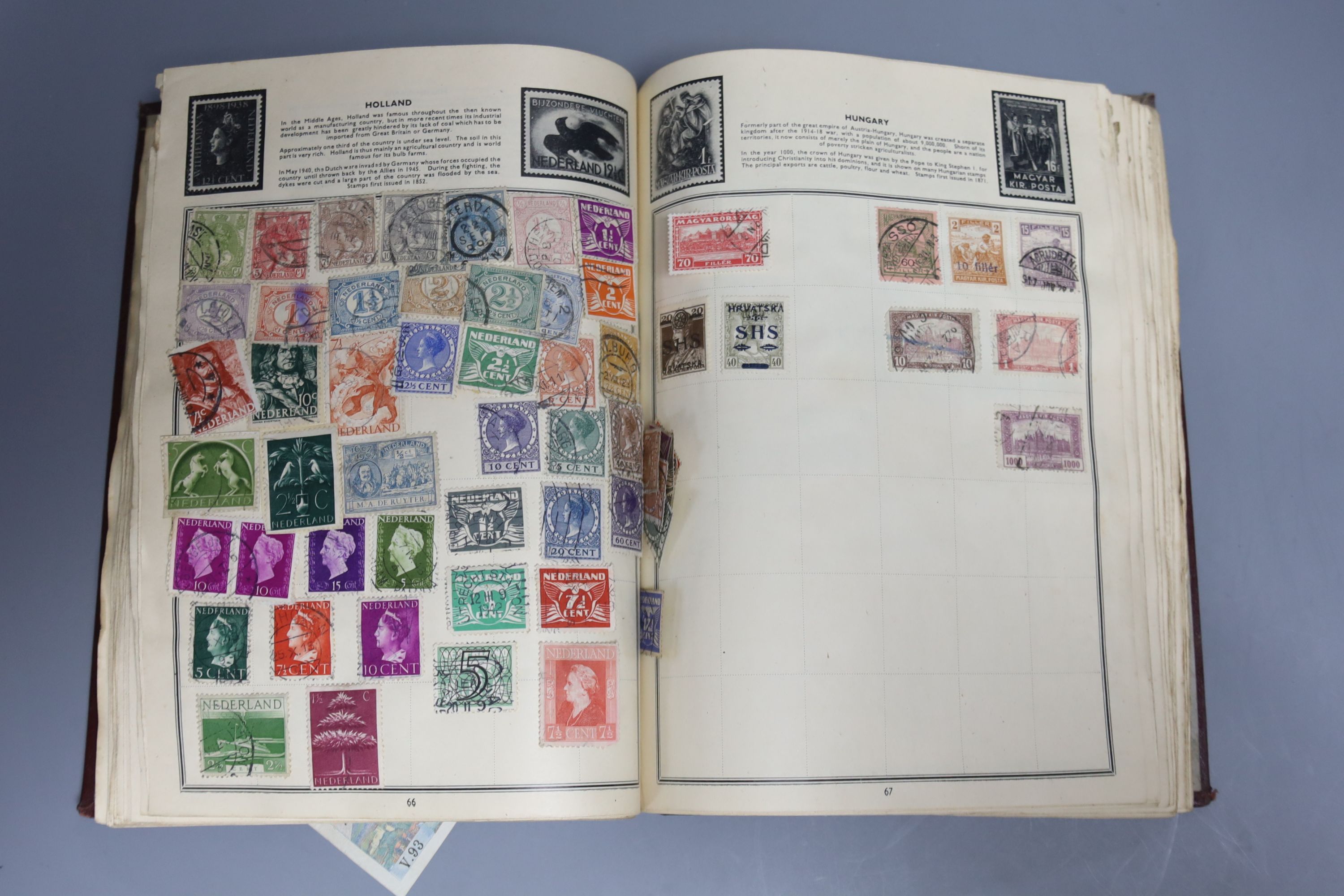 A Pacific stamp album with mixed world stamps, together with two pairs of brass candlesticks (5)